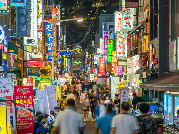 A photo of a crowded street downtown in Busan, South Korea.